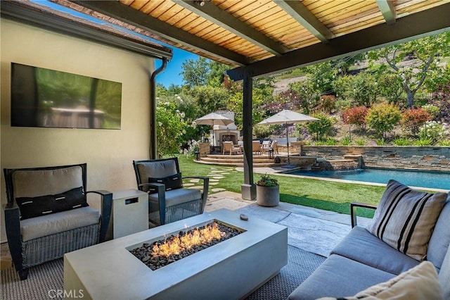 view of patio featuring an outdoor living space with a fire pit and an outdoor pool