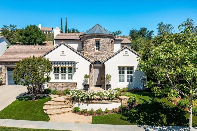 view of front of property with stone siding, stucco siding, concrete driveway, and a front lawn