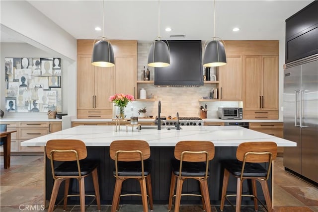 kitchen with stainless steel built in refrigerator, open shelves, exhaust hood, tasteful backsplash, and a sink