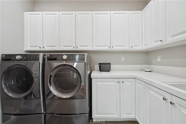 washroom featuring cabinet space and washer and dryer