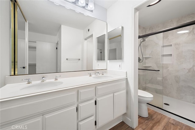 26932 Begonia Pl, Mission Viejo, CA 92692 - bathroom featuring a shower stall, wood finished floors, toilet, and double vanity