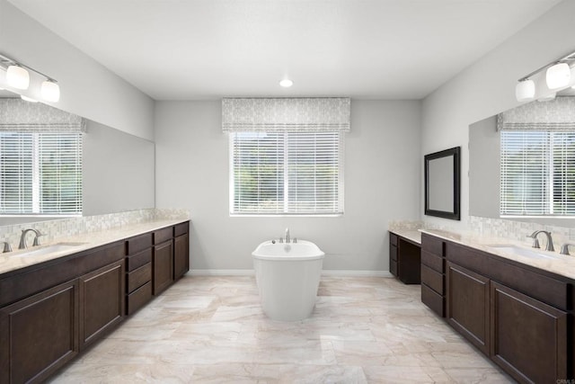 1797 Santa Christina Ave, Chula Vista, CA 91913 - bathroom featuring a freestanding tub, two vanities, and plenty of natural light