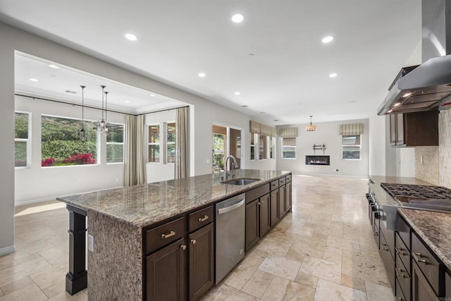 1797 Santa Christina Ave, Chula Vista, CA 91913 - kitchen featuring wall chimney range hood, stainless steel appliances, stone tile flooring, recessed lighting, and a kitchen island with sink