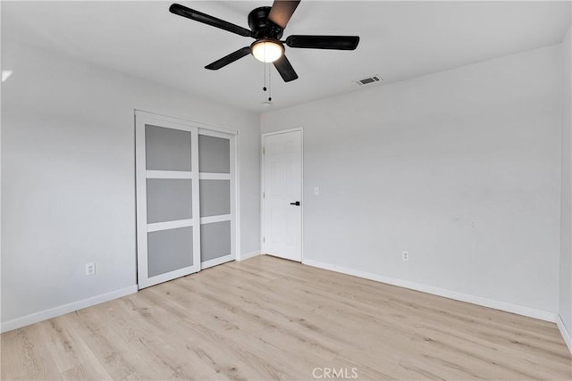 unfurnished bedroom featuring wood finished floors, baseboards, and a ceiling fan