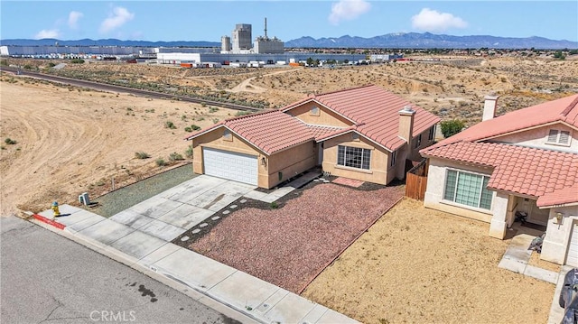 view of subject property featuring mountains and a desert landscape