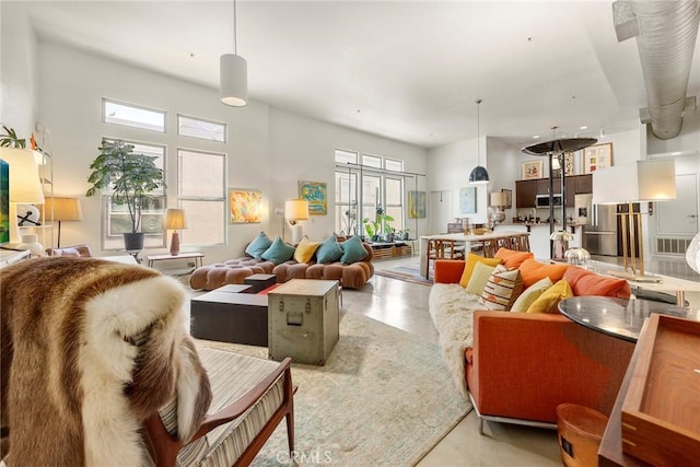 253 N Bush St, Santa Ana, CA 92701 - living room featuring healthy amount of natural light and finished concrete floors