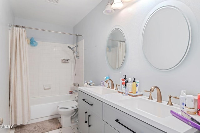 bathroom featuring tile patterned floors, toilet, double vanity, and shower / bath combo with shower curtain