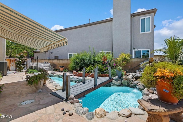 view of swimming pool with a fenced backyard, a patio area, and central AC unit