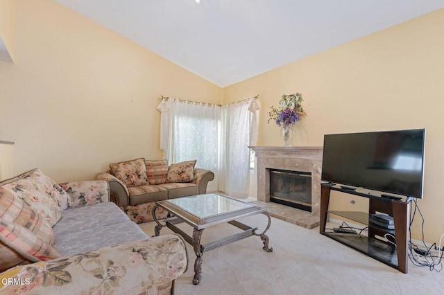 living room with lofted ceiling, a premium fireplace, and carpet flooring