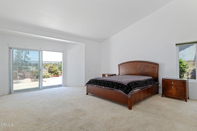 carpeted bedroom with access to exterior and vaulted ceiling