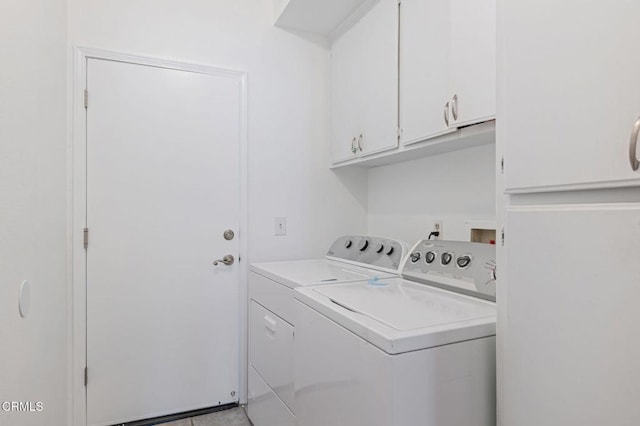 clothes washing area with cabinet space and separate washer and dryer