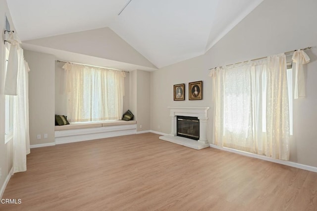 4078 Bending Oak Ct, Moorpark, CA 93021 - unfurnished living room featuring lofted ceiling, a glass covered fireplace, and light wood-type flooring