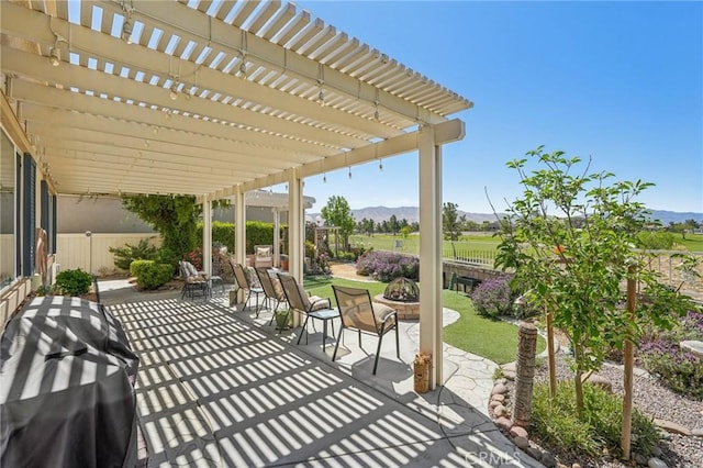 19575 Vermillion Ln, Apple Valley, CA 92308 - view of patio / terrace with a mountain view, an outdoor fire pit, a fenced backyard, and a pergola