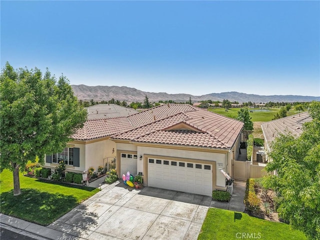 19575 Vermillion Ln, Apple Valley, CA 92308 - mediterranean / spanish-style home featuring an attached garage, concrete driveway, stucco siding, and a mountain view