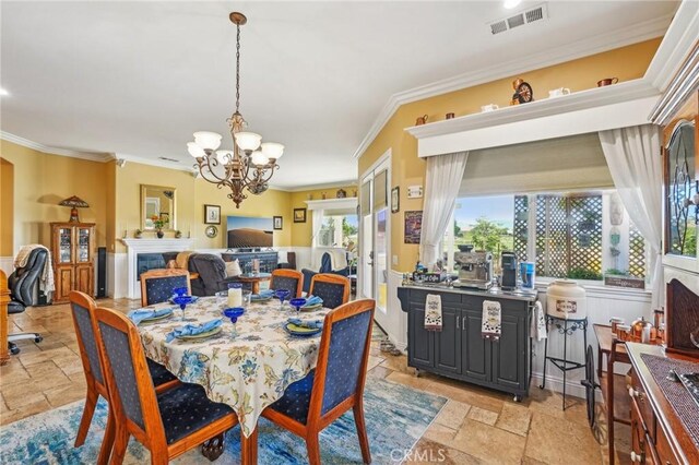 19575 Vermillion Ln, Apple Valley, CA 92308 - dining room with crown molding, a chandelier, stone tile flooring, and a fireplace