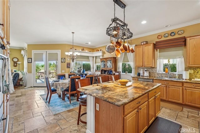 19575 Vermillion Ln, Apple Valley, CA 92308 - kitchen featuring stone tile flooring, a sink, a chandelier, a kitchen island, and crown molding