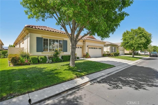 19575 Vermillion Ln, Apple Valley, CA 92308 - view of front of home with an attached garage, driveway, stucco siding, and a front lawn