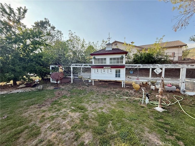 9869 Kehl Canyon Rd, Cherry Valley, CA 92223 - rear view of house with exterior structure and a lawn