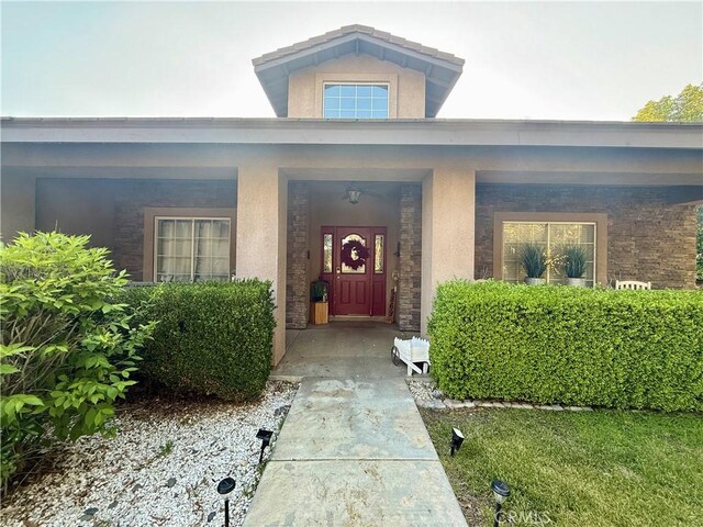 9869 Kehl Canyon Rd, Cherry Valley, CA 92223 - property entrance with stone siding and stucco siding