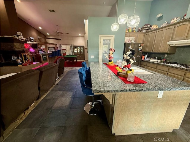 9869 Kehl Canyon Rd, Cherry Valley, CA 92223 - kitchen featuring freestanding refrigerator, under cabinet range hood, white gas cooktop, tasteful backsplash, and billiards