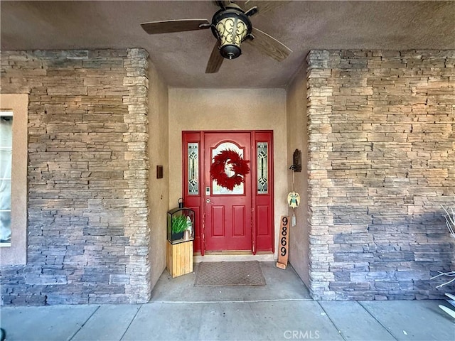 9869 Kehl Canyon Rd, Cherry Valley, CA 92223 - entrance to property featuring ceiling fan and stucco siding