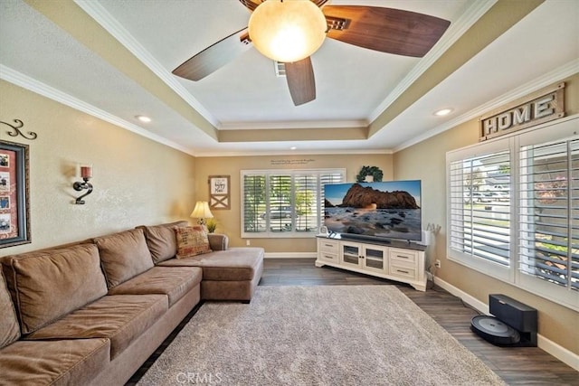 1266 Marina Rd, Corona, CA 92880 - living area featuring a tray ceiling, crown molding, dark wood-style floors, ceiling fan, and baseboards