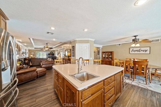 1266 Marina Rd, Corona, CA 92880 - kitchen with freestanding refrigerator, ceiling fan, a sink, brown cabinets, and light countertops