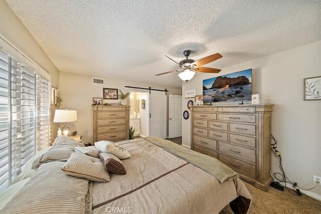 1266 Marina Rd, Corona, CA 92880 - bedroom featuring a barn door, carpet flooring, a textured ceiling, a ceiling fan, and baseboards