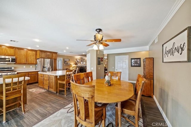 1266 Marina Rd, Corona, CA 92880 - dining space with ceiling fan, ornamental molding, wood finished floors, baseboards, and recessed lighting