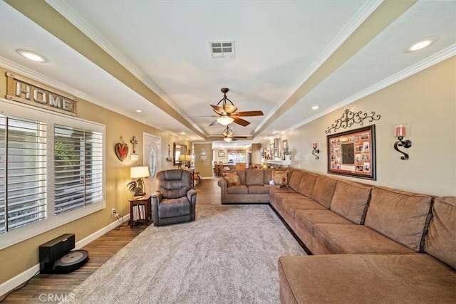 1266 Marina Rd, Corona, CA 92880 - living room featuring wood finished floors, a raised ceiling, healthy amount of natural light, crown molding, and ceiling fan