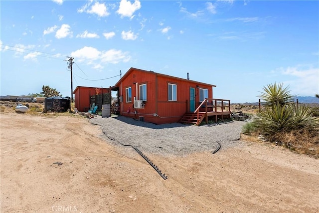59101 Joshua Dr, Yucca Valley, CA 92284 - view of home's exterior featuring a wooden deck and cooling unit