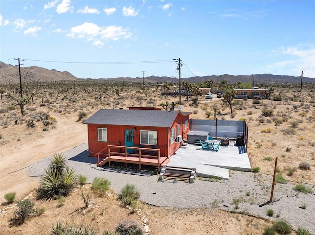 59101 Joshua Dr, Yucca Valley, CA 92284 - rear view of property featuring view of desert, a deck with mountain view, a view of countryside, and a covered hot tub
