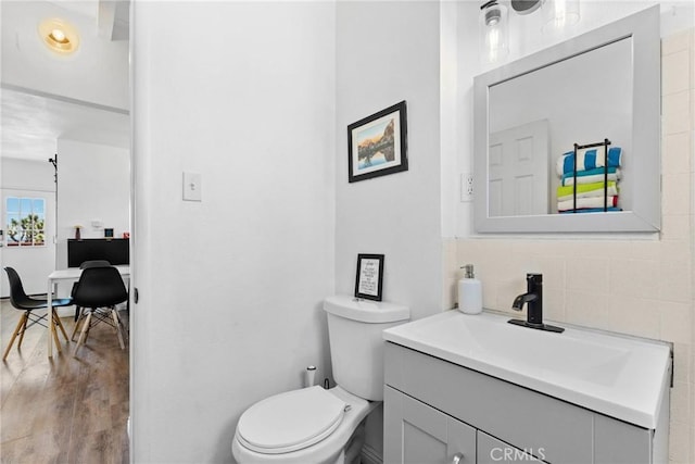 59101 Joshua Dr, Yucca Valley, CA 92284 - bathroom with vanity, toilet, wood finished floors, and decorative backsplash