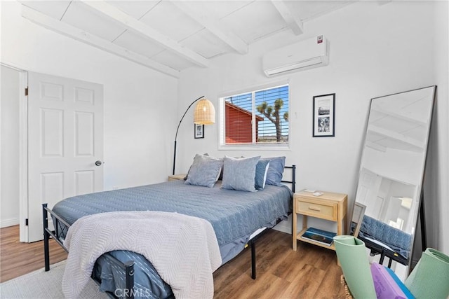59101 Joshua Dr, Yucca Valley, CA 92284 - bedroom with a wall mounted air conditioner, wood finished floors, and beam ceiling