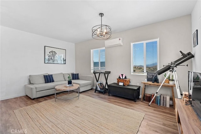 59101 Joshua Dr, Yucca Valley, CA 92284 - living area with wood finished floors, a wall mounted AC, a chandelier, and baseboards