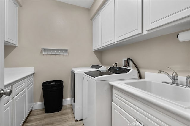 14215 Rolling Stream Pl, Eastvale, CA 92880 - laundry room featuring cabinet space, separate washer and dryer, light wood-type flooring, and baseboards