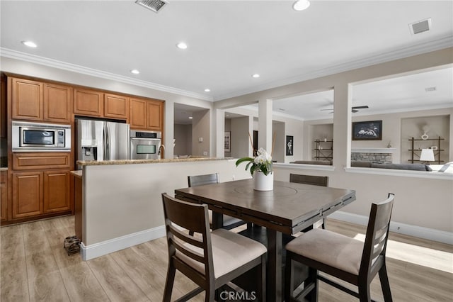 14215 Rolling Stream Pl, Eastvale, CA 92880 - dining area featuring light wood finished floors, recessed lighting, crown molding, ceiling fan, and baseboards