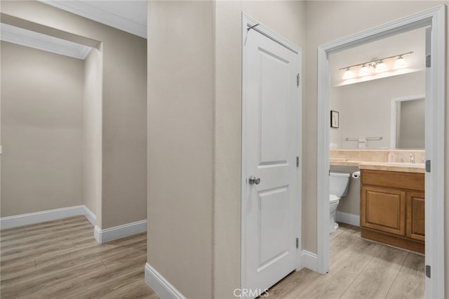 14215 Rolling Stream Pl, Eastvale, CA 92880 - hallway with light wood-style flooring, baseboards, and ornamental molding
