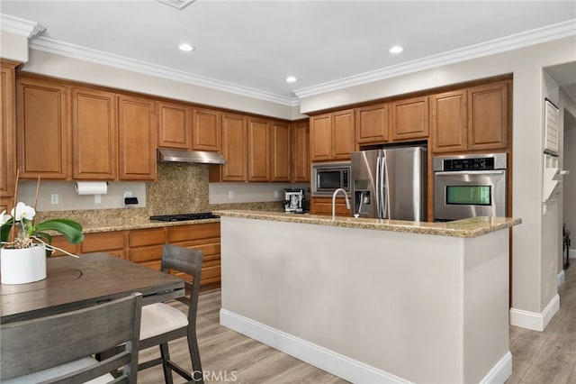 14215 Rolling Stream Pl, Eastvale, CA 92880 - kitchen with appliances with stainless steel finishes, under cabinet range hood, brown cabinets, crown molding, and recessed lighting