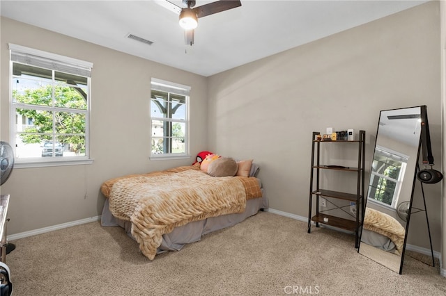14215 Rolling Stream Pl, Eastvale, CA 92880 - carpeted bedroom featuring multiple windows, baseboards, and a ceiling fan