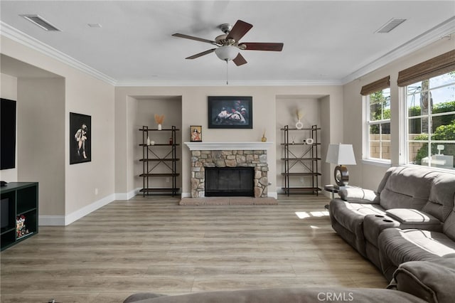 14215 Rolling Stream Pl, Eastvale, CA 92880 - living room featuring a ceiling fan, light wood finished floors, crown molding, baseboards, and a fireplace