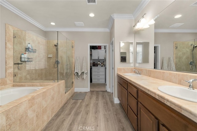 14215 Rolling Stream Pl, Eastvale, CA 92880 - full bathroom with a shower stall, a bath, double vanity, wood finished floors, and recessed lighting