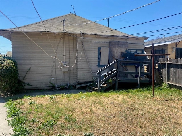 back of property featuring a shingled roof