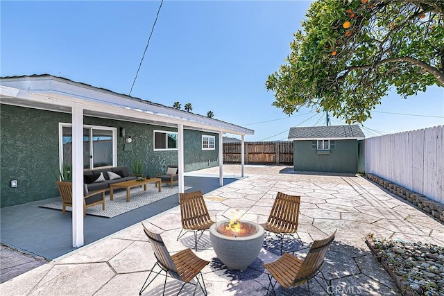 654 Carina Dr, Lompoc, CA 93436 - view of patio featuring a fenced backyard, an outdoor fire pit, an outdoor structure, and a storage shed
