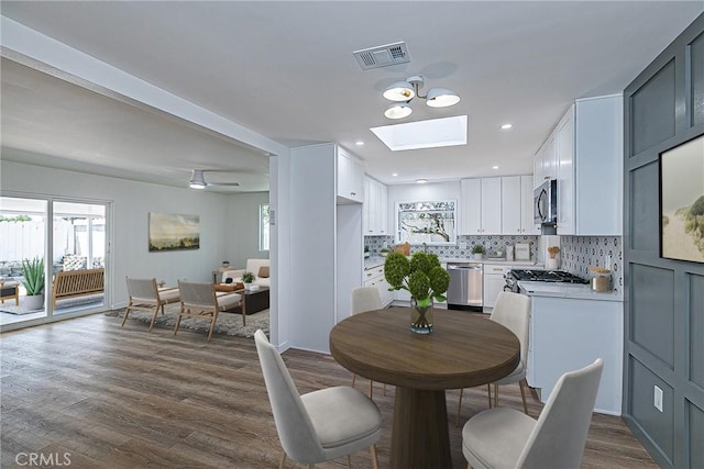 654 Carina Dr, Lompoc, CA 93436 - dining room featuring a skylight and dark wood-style flooring