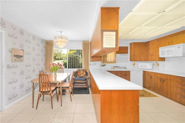 18132 James Rd, Villa Park, CA 92861 - kitchen with white appliances, brown cabinetry, a peninsula, light countertops, and wallpapered walls
