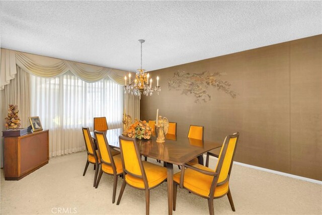 18132 James Rd, Villa Park, CA 92861 - dining space with a chandelier, light carpet, a textured ceiling, and baseboards