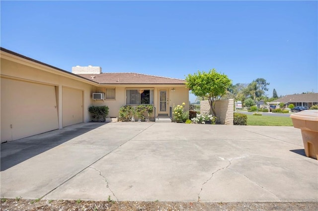 18132 James Rd, Villa Park, CA 92861 - ranch-style home featuring stucco siding, an attached garage, a chimney, driveway, and a wall mounted AC