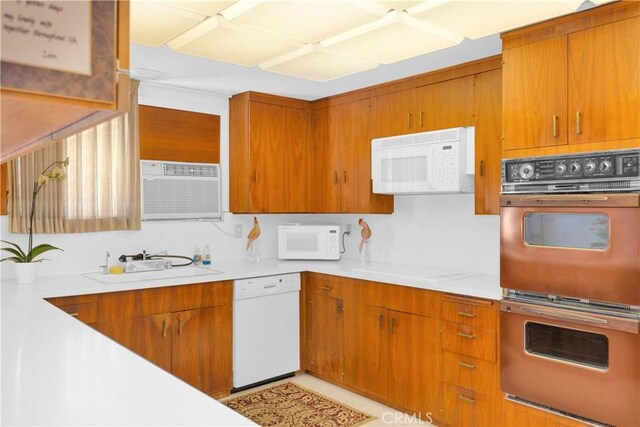 18132 James Rd, Villa Park, CA 92861 - kitchen featuring white appliances, a sink, light countertops, and brown cabinets
