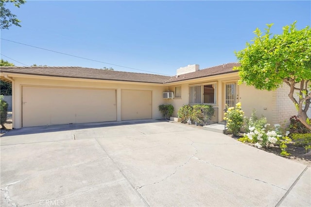 18132 James Rd, Villa Park, CA 92861 - single story home with a garage, driveway, stucco siding, and an AC wall unit